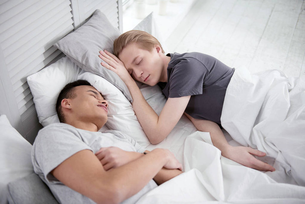 Peaceful gay couple sleeping - Фото, изображение