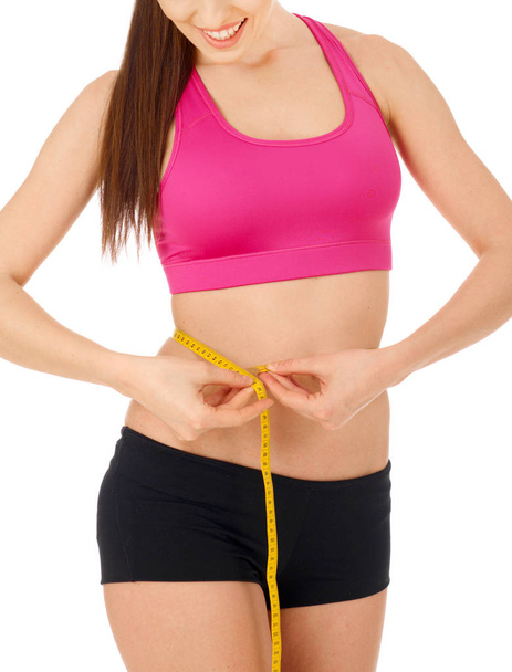 Slim woman with tape measure around her waist - Foto, imagen