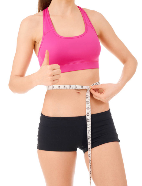 Slim woman with tape measure around her waist - Zdjęcie, obraz
