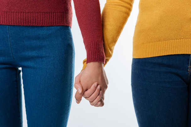 Female hands holding each other - Foto, afbeelding