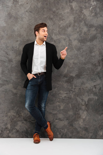 Shocked young businessman pointing. - 写真・画像