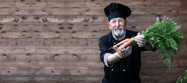 Chef old in uniform with vegetables - Photo, Image