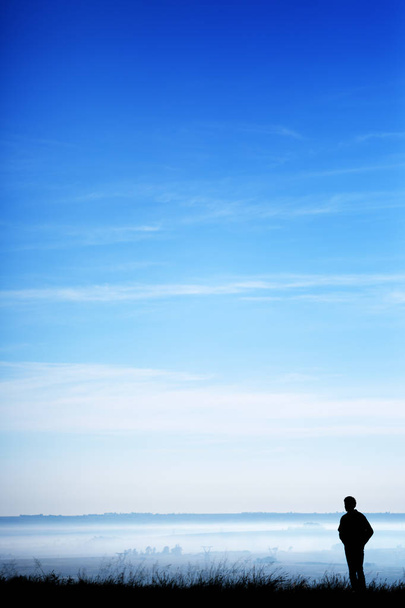 Молодий чоловік стоїть у величі природи
 - Фото, зображення