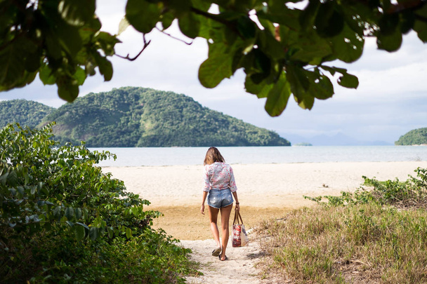 Girl walking to the beach of Paraty Mirim , Rio de Janeiro, Brazil - 写真・画像