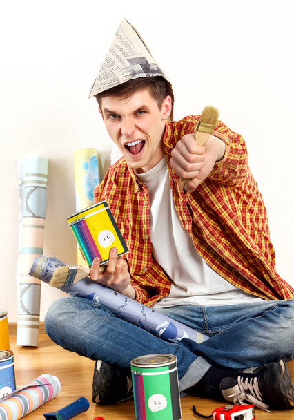 Repair home man holding paint roller for wallpaper. - Photo, Image
