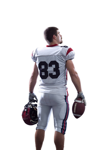 Portrait of American football player pointing against white back - 写真・画像