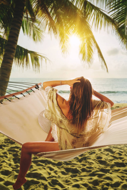 Woman on a hammock relaxing at the beach - Φωτογραφία, εικόνα