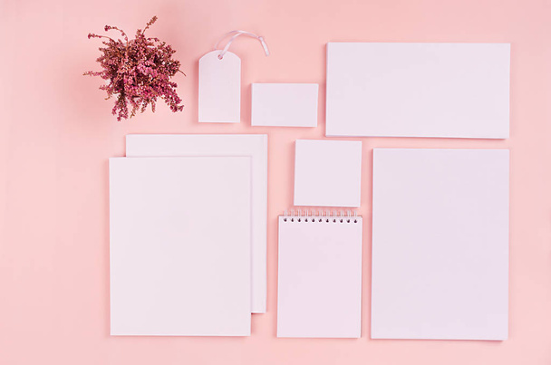 Modern minimalistic workspace with white blank stationery on soft pastel pink background, top view. - Photo, Image
