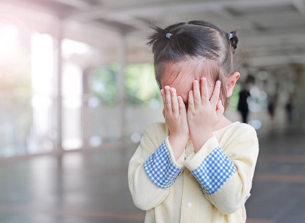 Asian little girl cover her face with her hands - Photo, Image