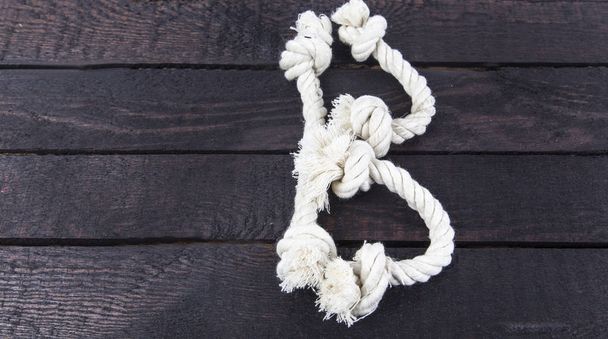 shaped the letter with rope on wooden background. - Photo, Image