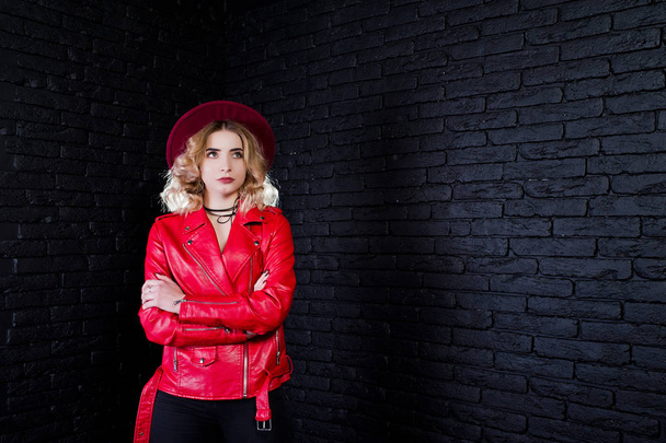 Studio portrait of blonde girl in red hat and leather jacket aga - Zdjęcie, obraz