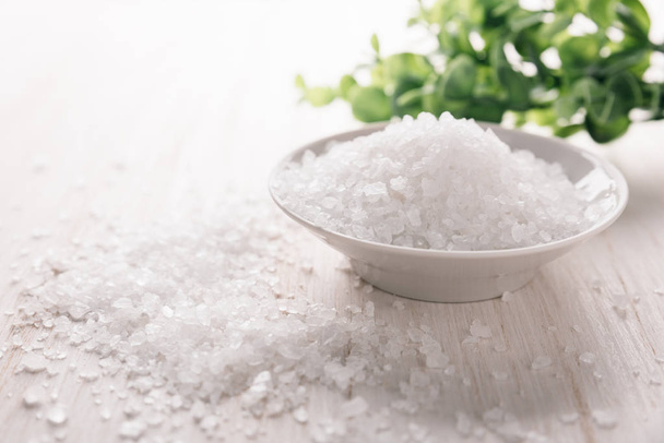 Sea salt in a bowl on wooden background. - Photo, Image
