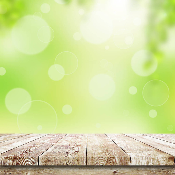 Green bokeh and sunlight and wood table. Beauty natural background - Foto, immagini