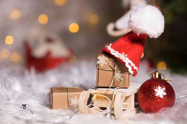 Winter holidays background: Christmas presents on mini wooden sl - Photo, Image
