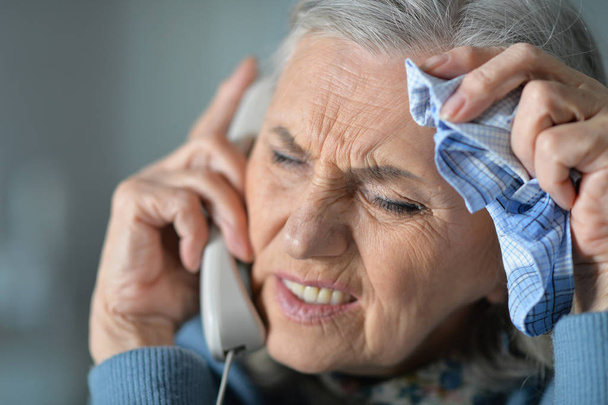 Portrait of upset senior woman calling doctor  - Valokuva, kuva
