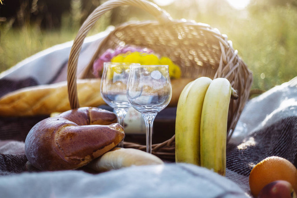 picnic, plaid, basket with wine, bread and fruit - Photo, Image