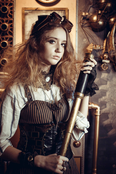 Portrait of a beautiful steampunk woman, with a telescope on a g - Foto, afbeelding