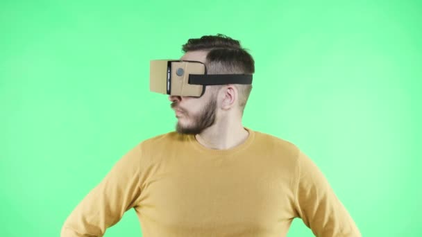 Man in vr headset enjoy on the green background - Footage, Video