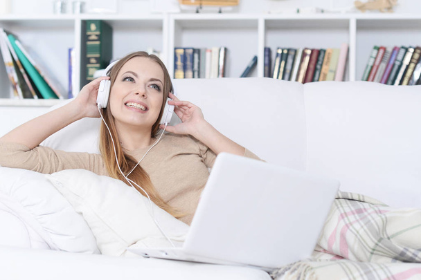 young beautiful woman  listening to music on sofa  at home - Photo, image