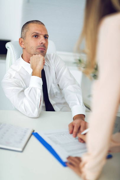 Businessman discussing plan with female colleague. - Foto, Imagen