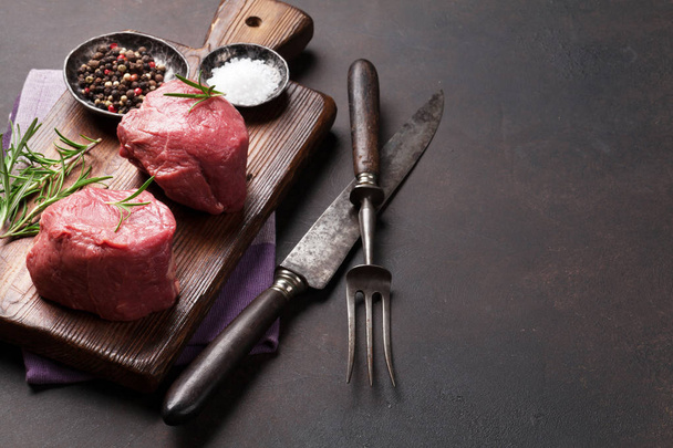 Raw fillet steak cooking on stone table. With space for your text - Photo, Image