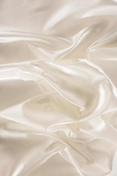 ivory crumpled shiny silk fabric background - Fotó, kép