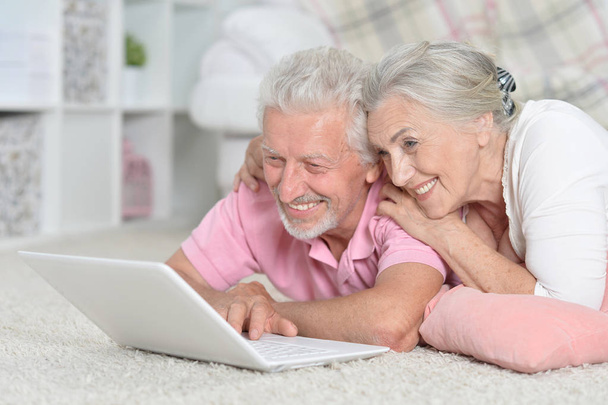 happy senior couple using  laptop  at home - Fotó, kép