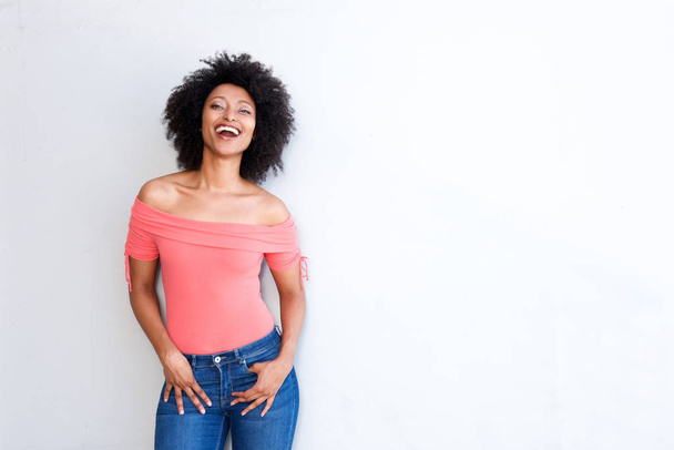 Portrait of confident young woman laughing against white background with copy space - Photo, Image