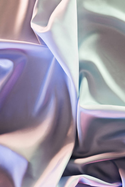 green and violet shiny silk fabric background - 写真・画像