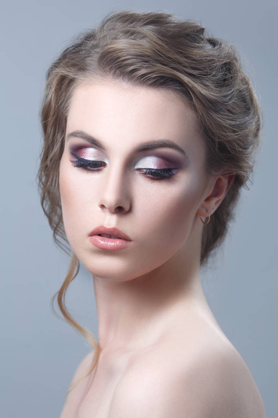 portrait of young woman with fashionable makeup on grey background - Foto, Imagem
