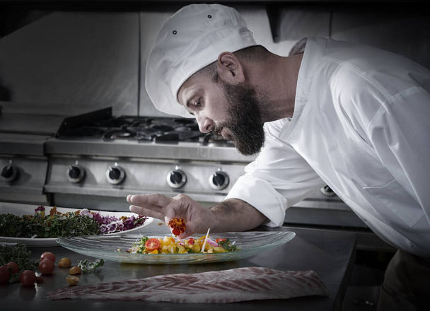 Chef garnishing flower in ceviche dish - Photo, Image