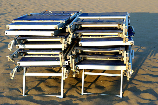 summer sea,  stack of sunbeds on the beach - Photo, Image
