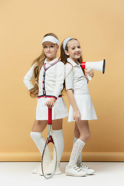 Portrait of two girls as tennis players holding tennis racket. Studio shot. - Фото, зображення