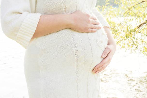 stomach pregnancy close up in white clothes. concept third trimester. concept expectation of the child - Fotoğraf, Görsel
