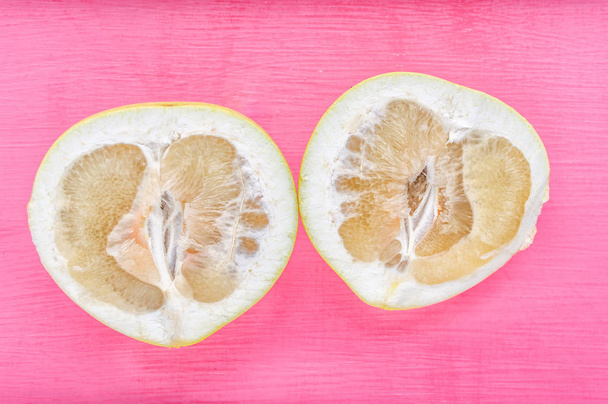 pomelo on a pink background close up. concept vitamins - Foto, Bild
