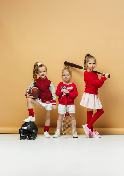 Happy and beautyful children show different sport. Studio fashion concept. Emotions concept. - Foto, afbeelding