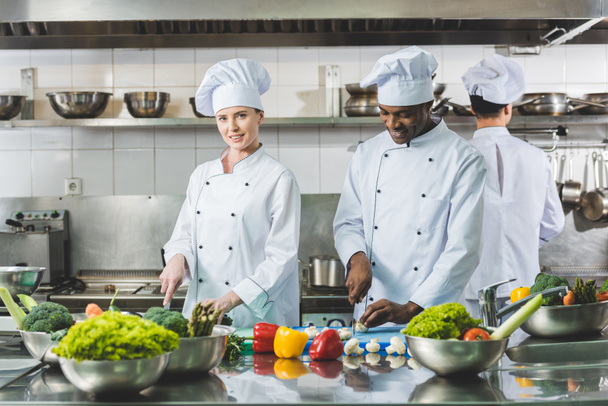 multicultural chefs cutting vegetables at restaurant kitchen - Photo, Image