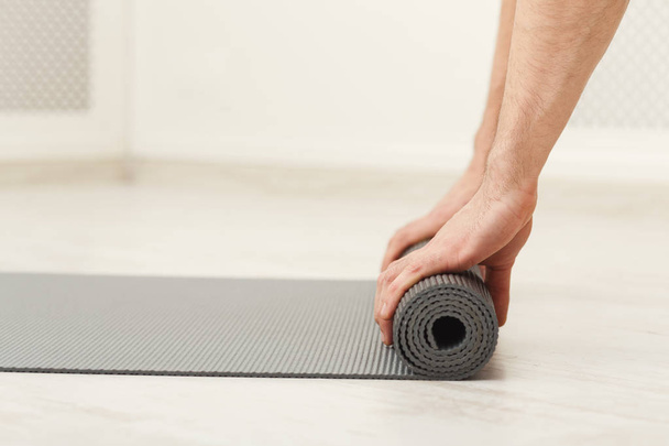 Rolling up fitness mat for exercise copy space - Фото, изображение