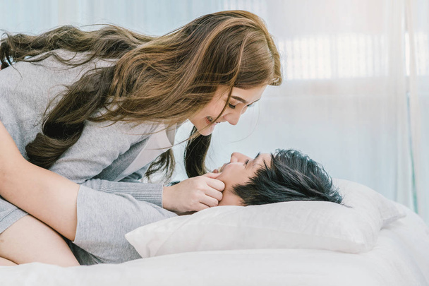 Closeup Happy Asian Lover kissing and hugging on the bed in bedroom at modern home, Couple and life style concept, - Foto, Imagem