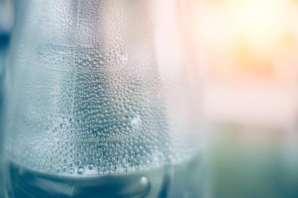 Water humid and condense transform to drops around the bottle - 写真・画像