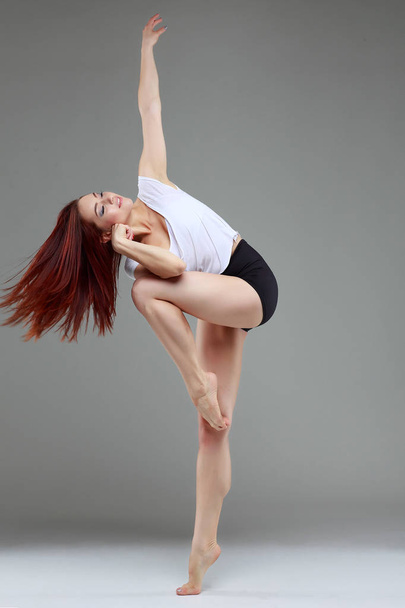 Beautiful ballet-dancer, modern style dancer posing on studio background. Contemporary - Foto, Bild