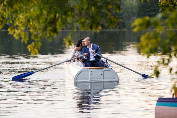 Young beautiful couple hugging, love each other, relax, boating - 写真・画像