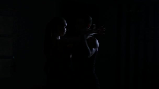 silhouette of a couple who dances in the training room - Footage, Video