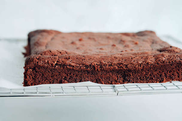 Chocolate brownie portions on white background. - 写真・画像