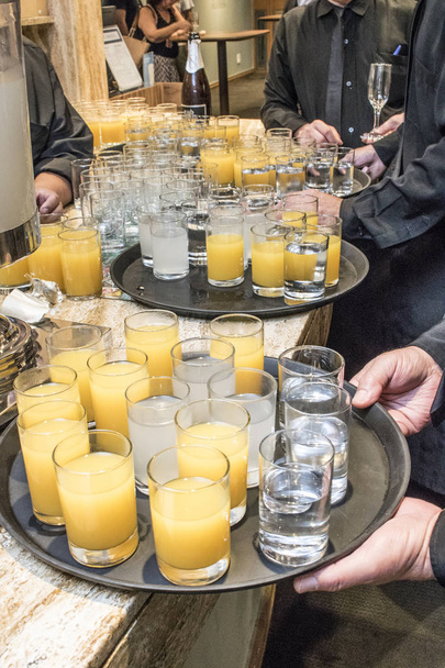 Sao Paulo, Brazil, February 28, 2018. Waiters prepare glasses with juice and coconut water to serve at a cocktail party in the city of Sao Paulo - Foto, Imagen