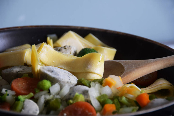 frozen dish, tagliatelle pasta with vegetables in a pan - 写真・画像