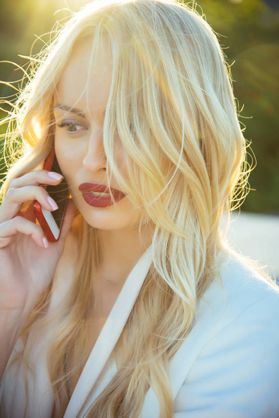 Girl with sexy red lips hold smartphone. - Foto, Imagem
