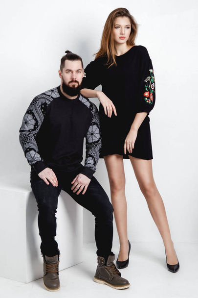 Fashion young couple over white background in trendy black clothes. - Zdjęcie, obraz