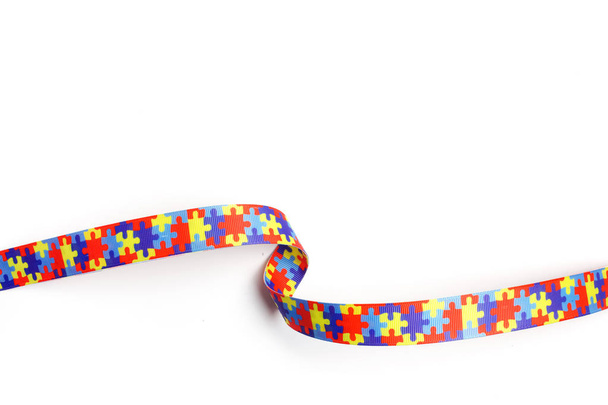 World Autism awareness and pride day with Puzzle pattern ribbon isolated on white - Foto, afbeelding