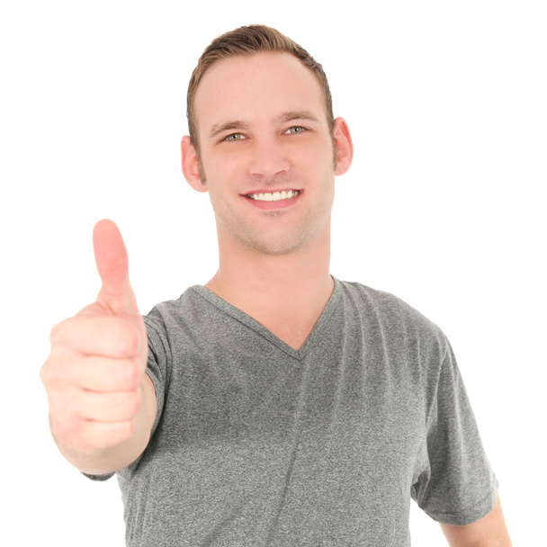 Handsome young man giving a thumbs up - Photo, Image